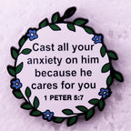 Decorative plaque with a biblical quote surrounded by flowers on a textured background